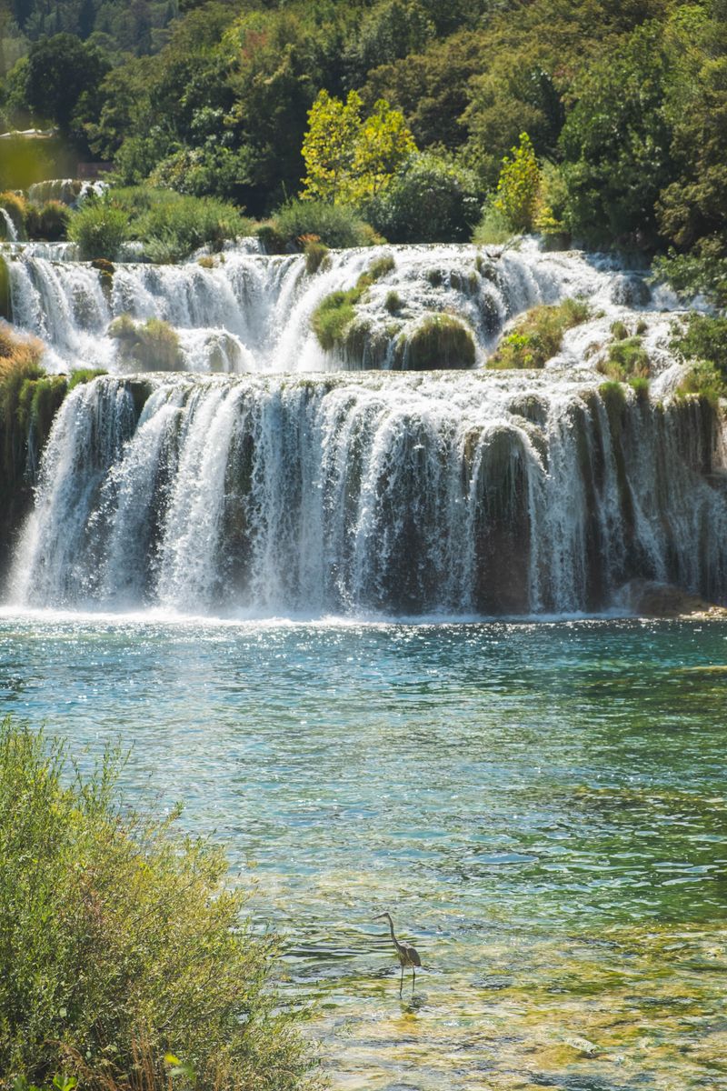 Beautiful view of waterfalls at Krka National Park, Croatia, with lush vegetation and wildlife.