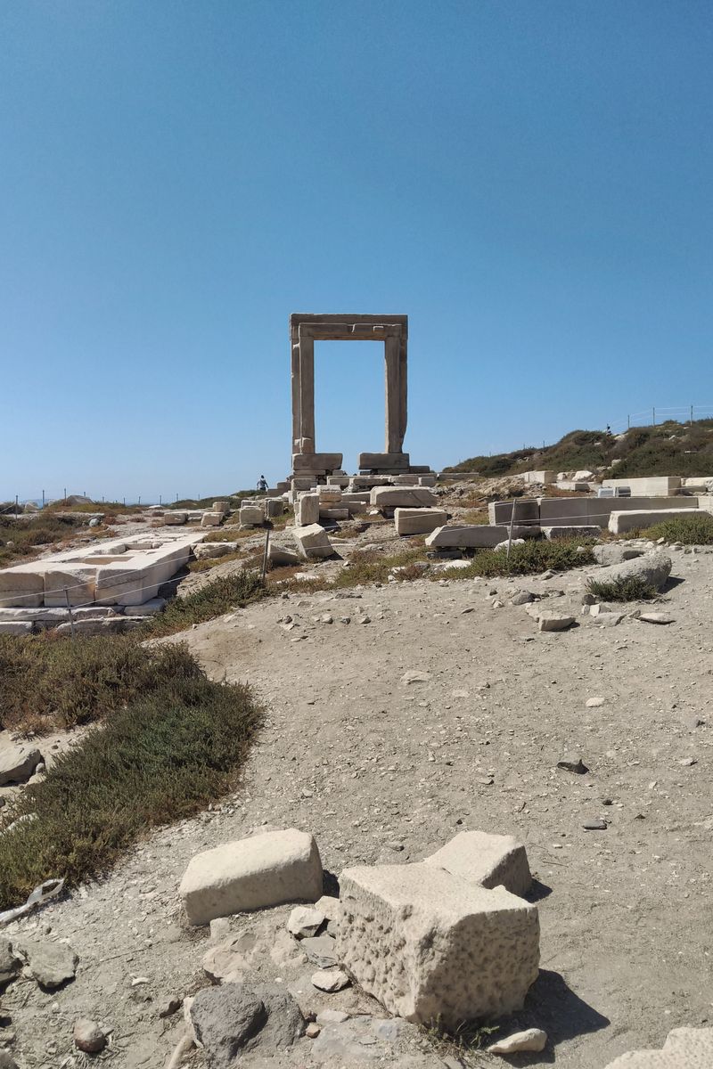Explore the majestic ruins of the Temple of Apollo on Naxos Island under clear blue skies.