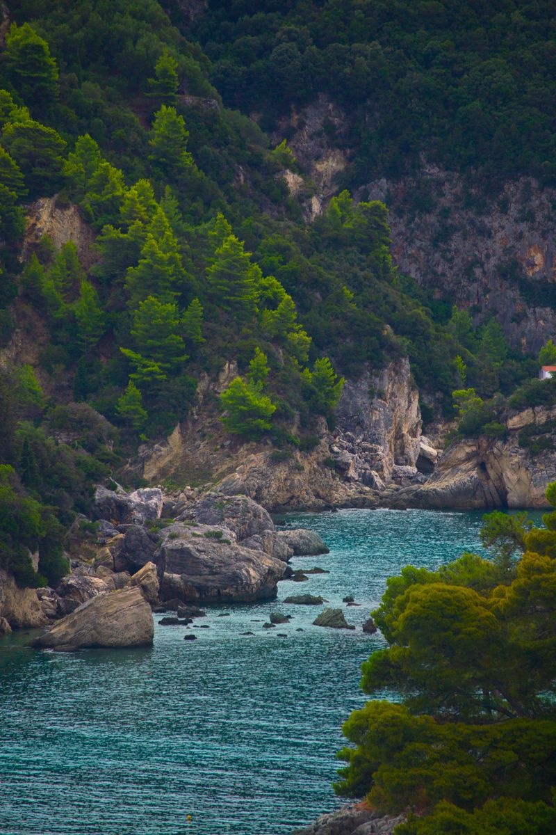 Breathtaking view of rocky cliffs and turquoise sea in Parga, Greece.