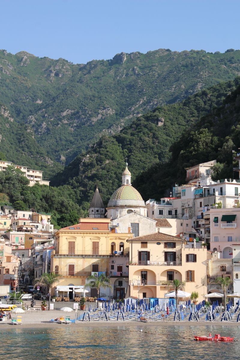 Charming coastal village of Cetara with colorful buildings and lush hills on the Amalfi Coast.