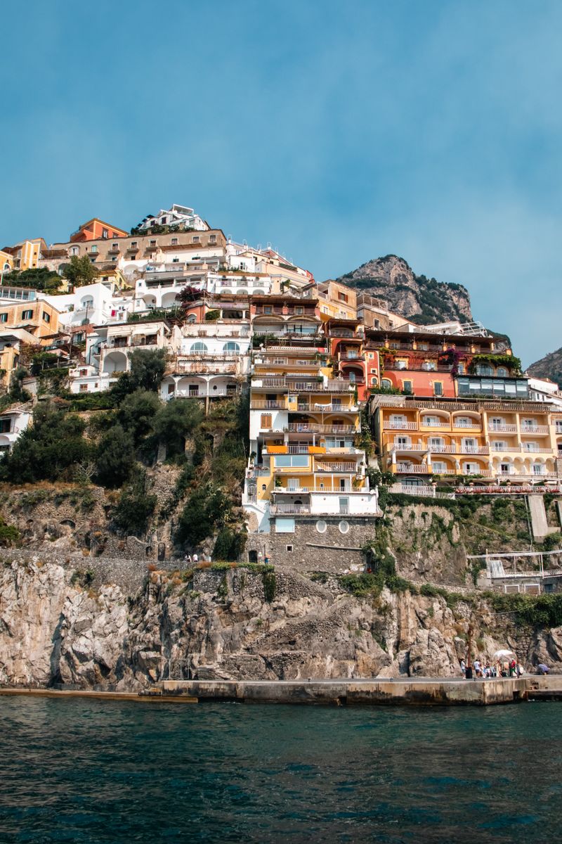 Vibrant cliffside houses in Positano, Italy, overlooking the deep blue sea.