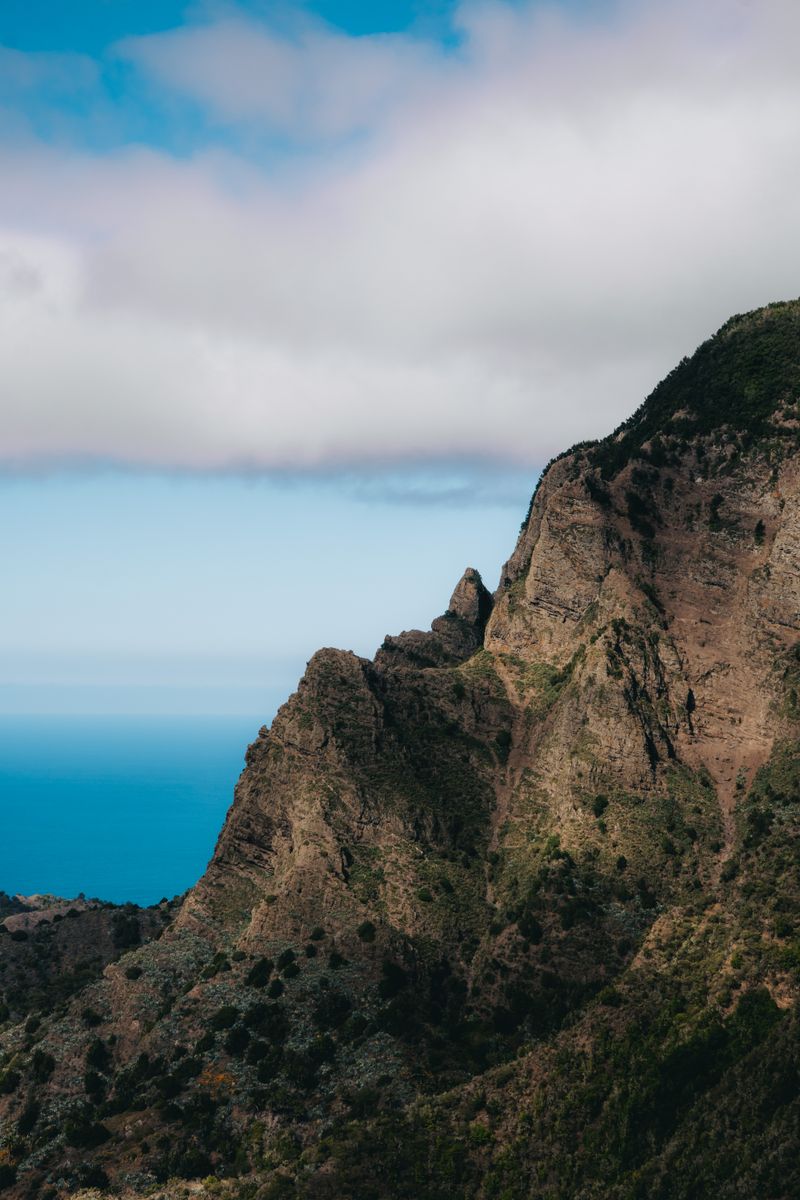 Panoramic view of rugged cliffs and ocean in La Gomera, showcasing dramatic landscapes.