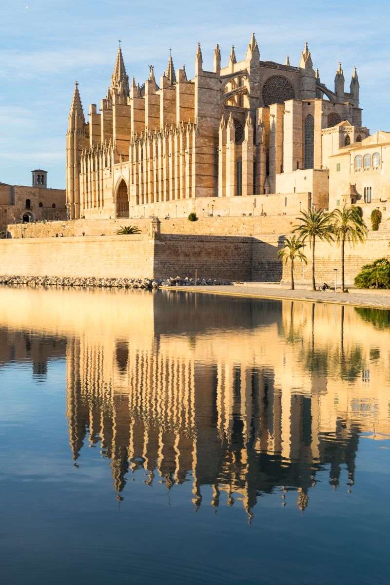 Stunning view of the Gothic Cathedral reflecting in water in Palma de Mallorca, Spain.
